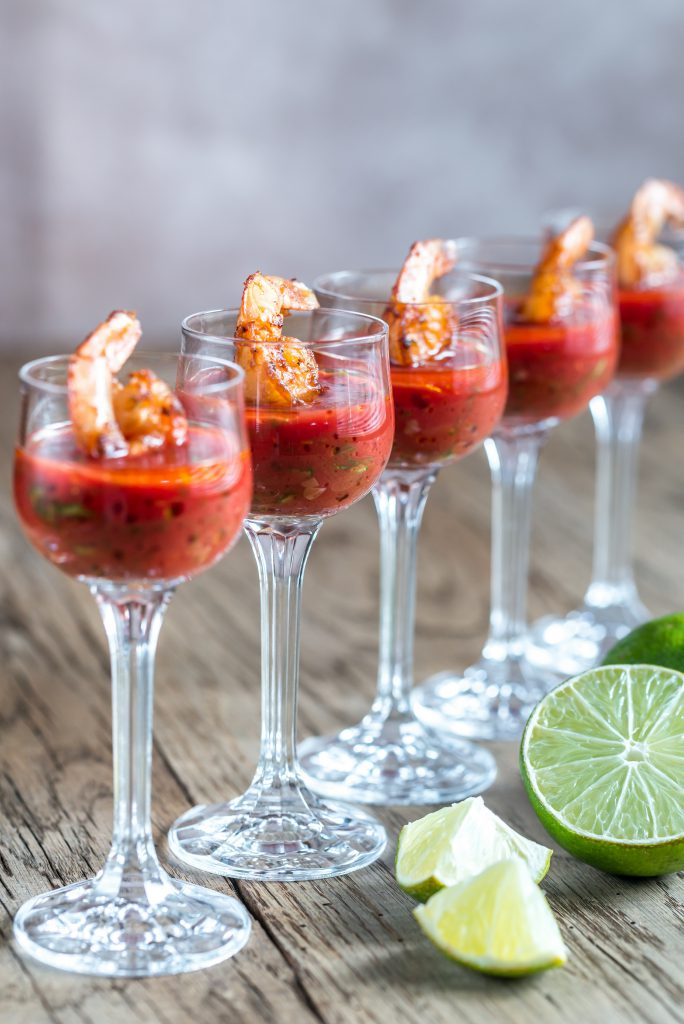 Shrimp cocktail with bloody caesar dipping sauce made with clam juice, ketchup, black pepper, Worcestershire, Tabasco, lemon, horseradish.