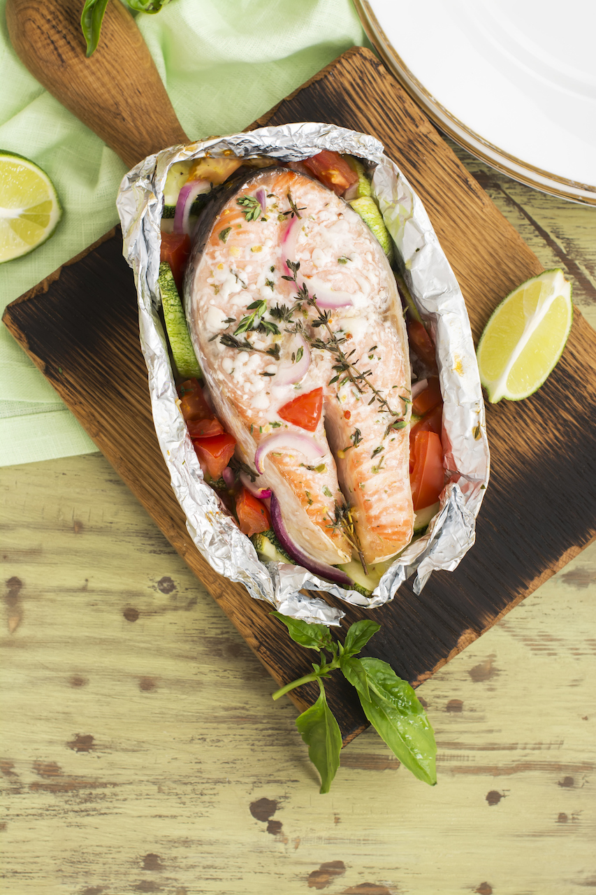 Oven baked salmon with vegetables in a foil pack. Perfect for the grill or in the oven.