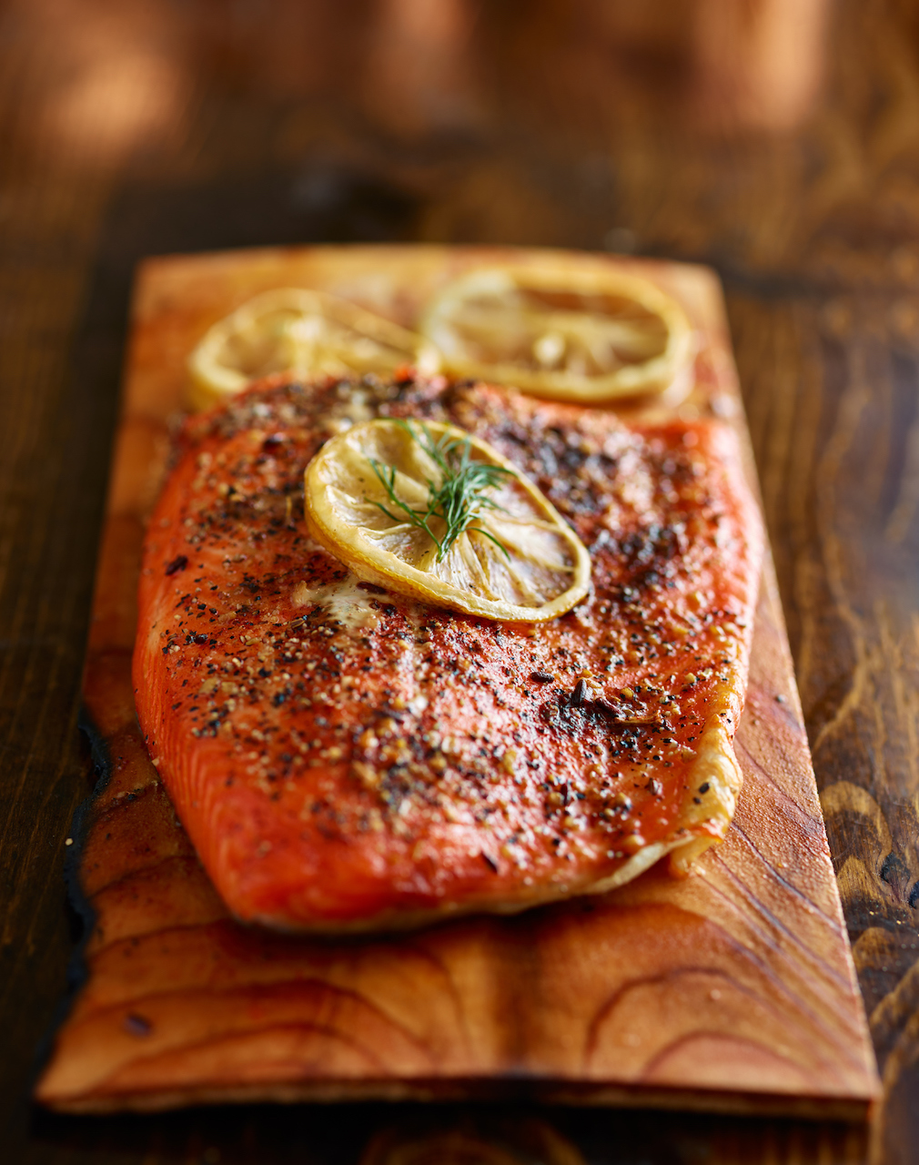 DOM Reserve salmon cooked on a cedar plank with lemon