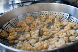 Learn how to steam fish or shrimp in a steamer basket.
