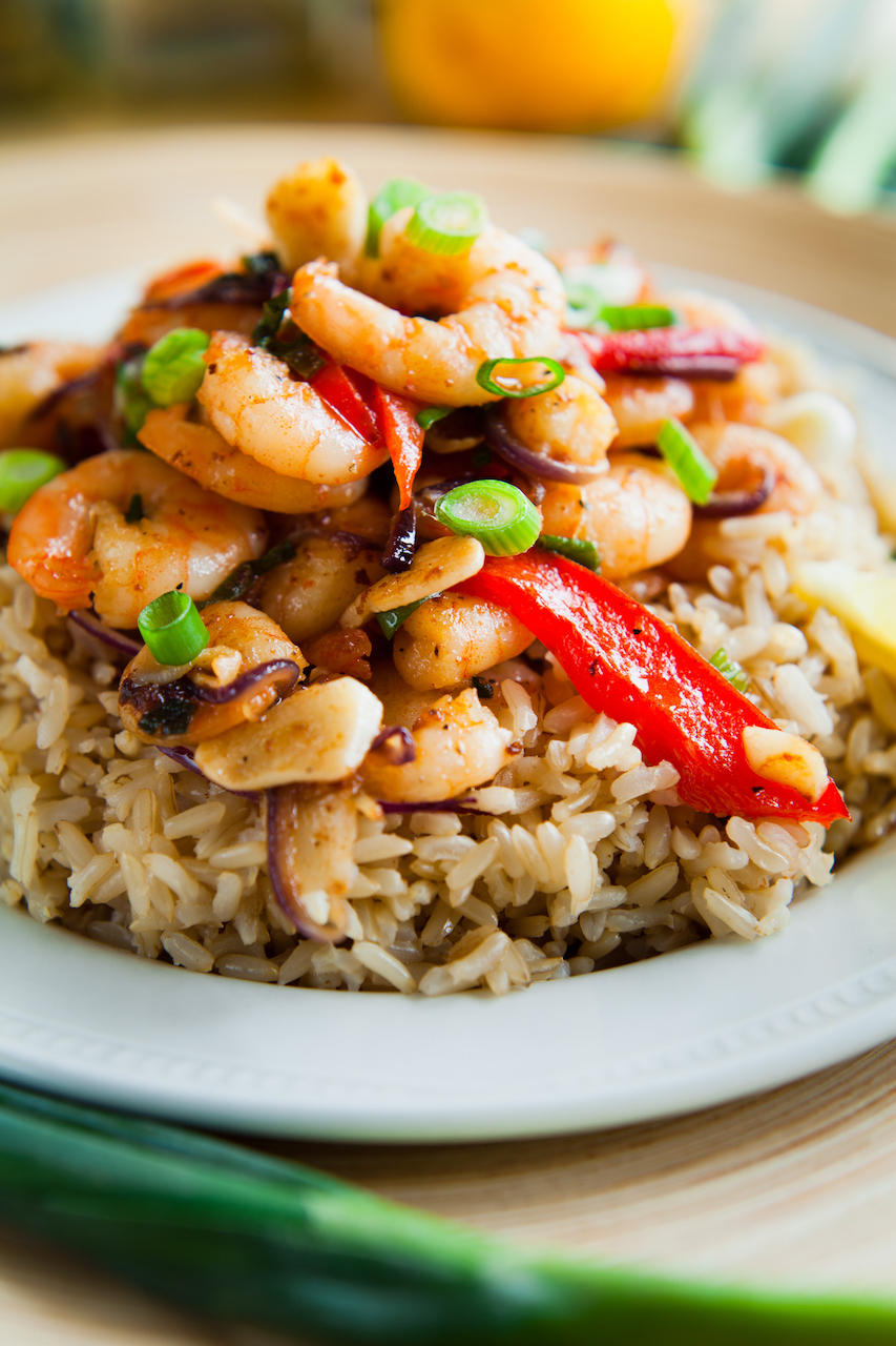 Shrimp stir-fry with rice, ginger, garlic, vegetables, chilies, onion, and lime. Great for kids or as a weekday dinner.